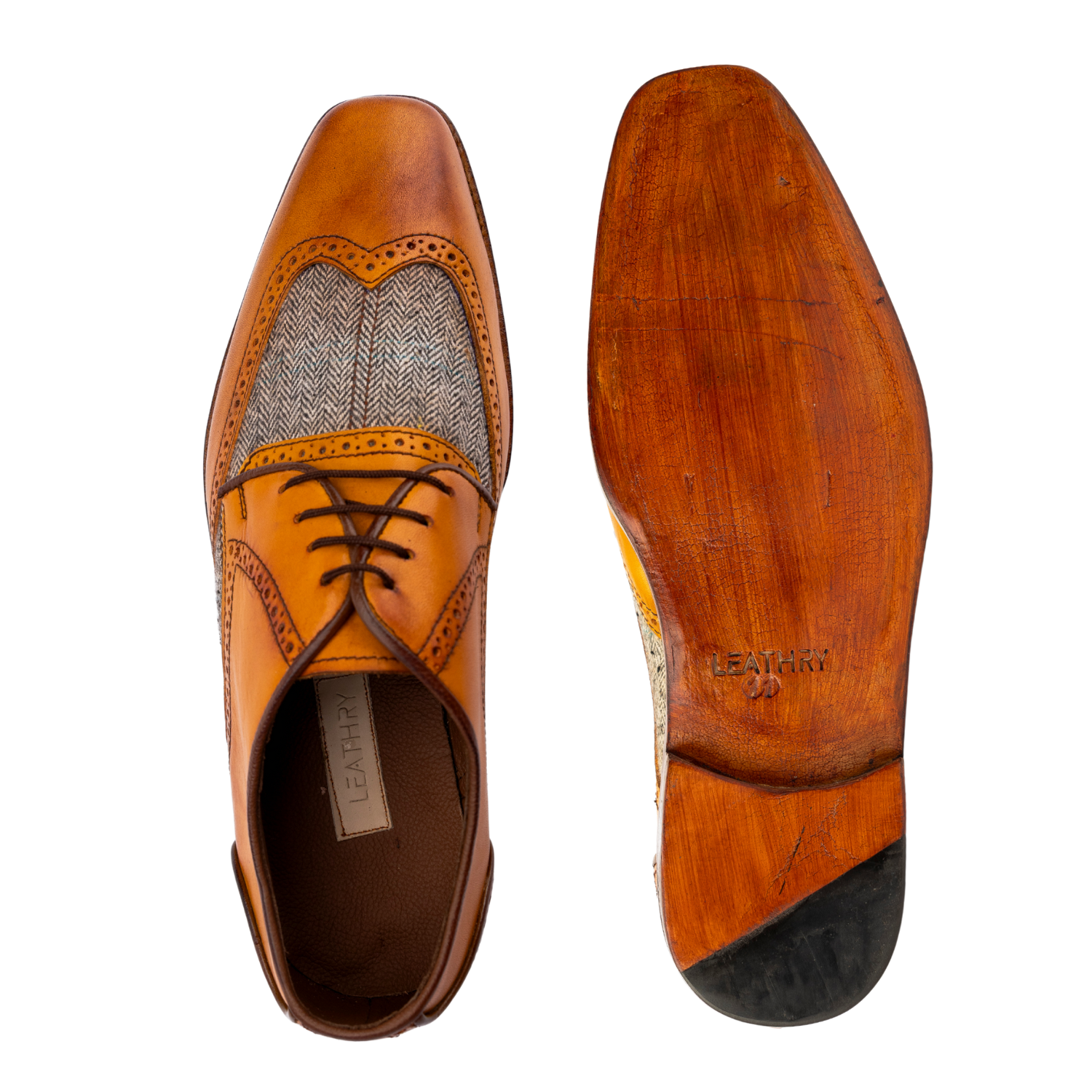 Brown leather dress shoes with detailed sole on a white background