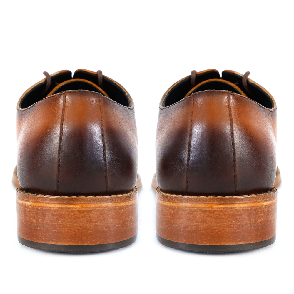 Brown leather dress shoes on a white background