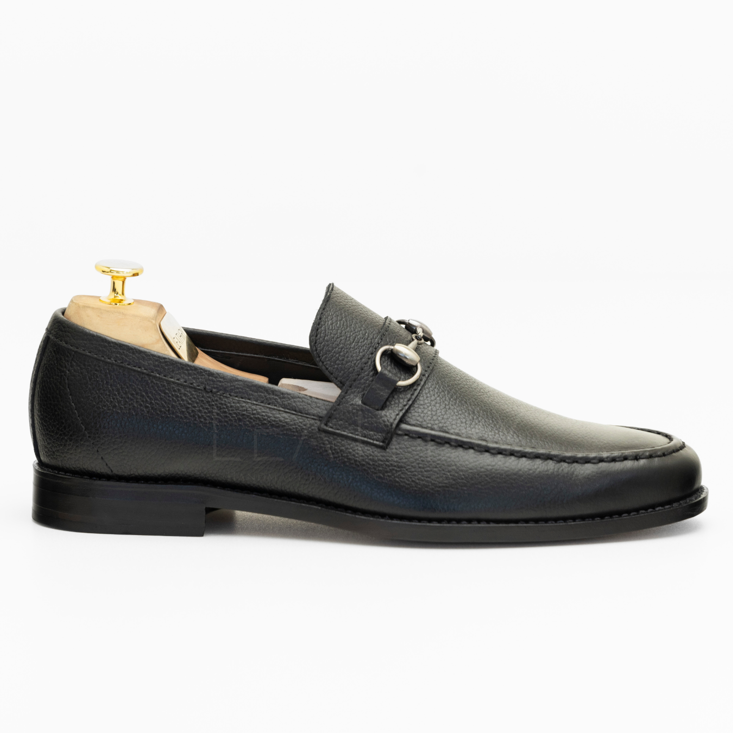 Black leather loafer shoe on a white background