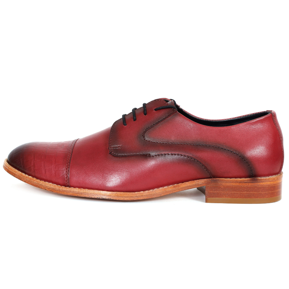 Red leather dress shoe on a white background