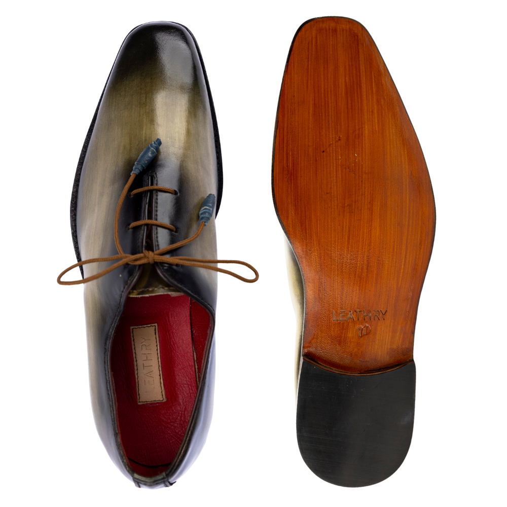 Black dress shoe with brown laces and wooden sole on a white background