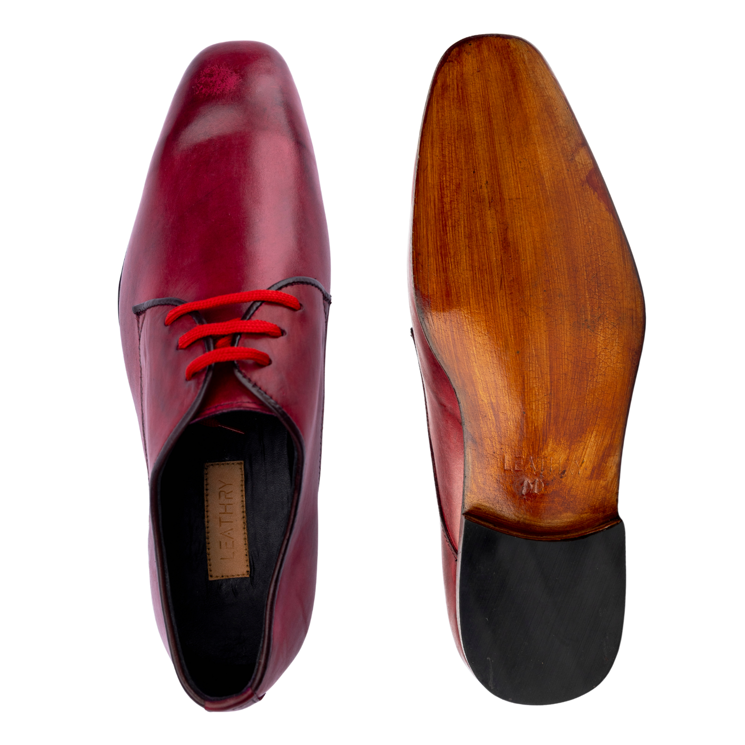 Maroon leather shoe with red laces and wooden sole on a white background