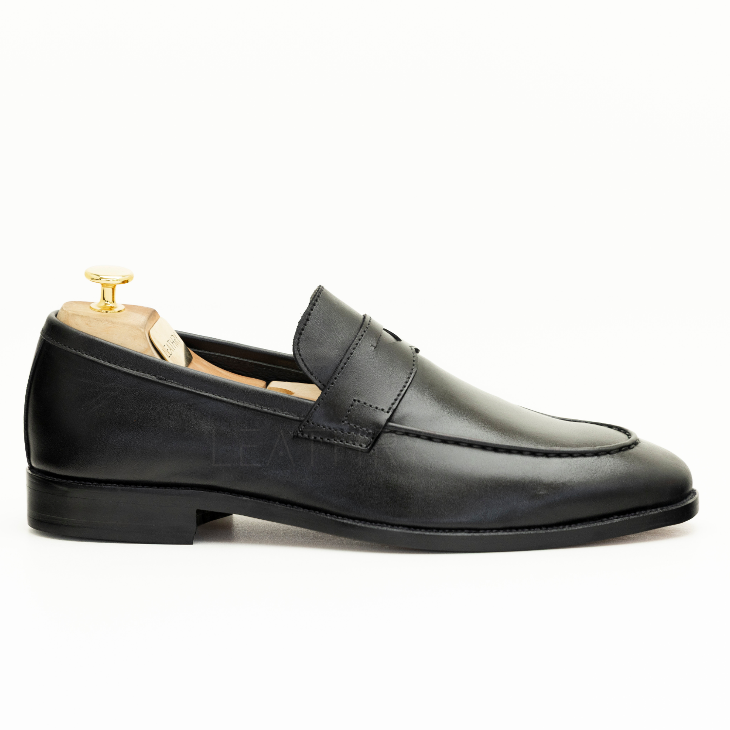 Black loafer shoe on a white background