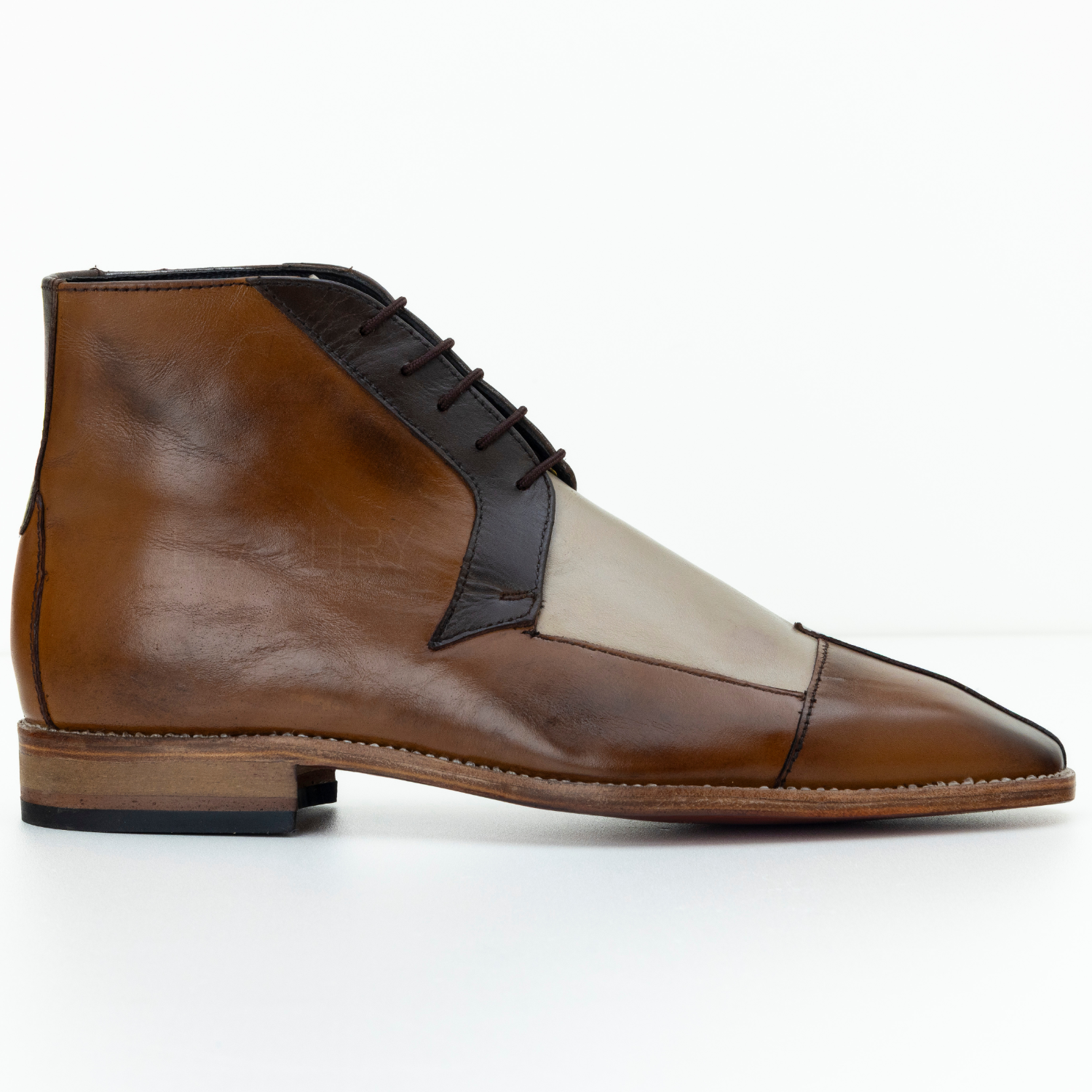 Brown leather shoe with a white insole on a white background