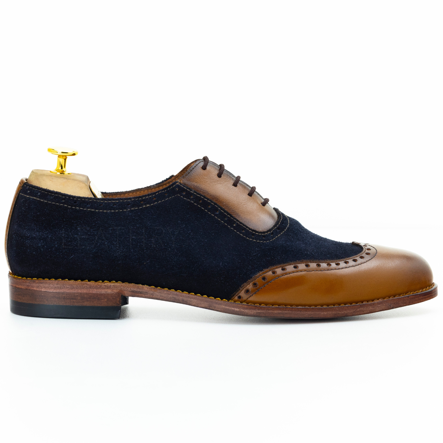 Navy and brown dress shoe on a white background