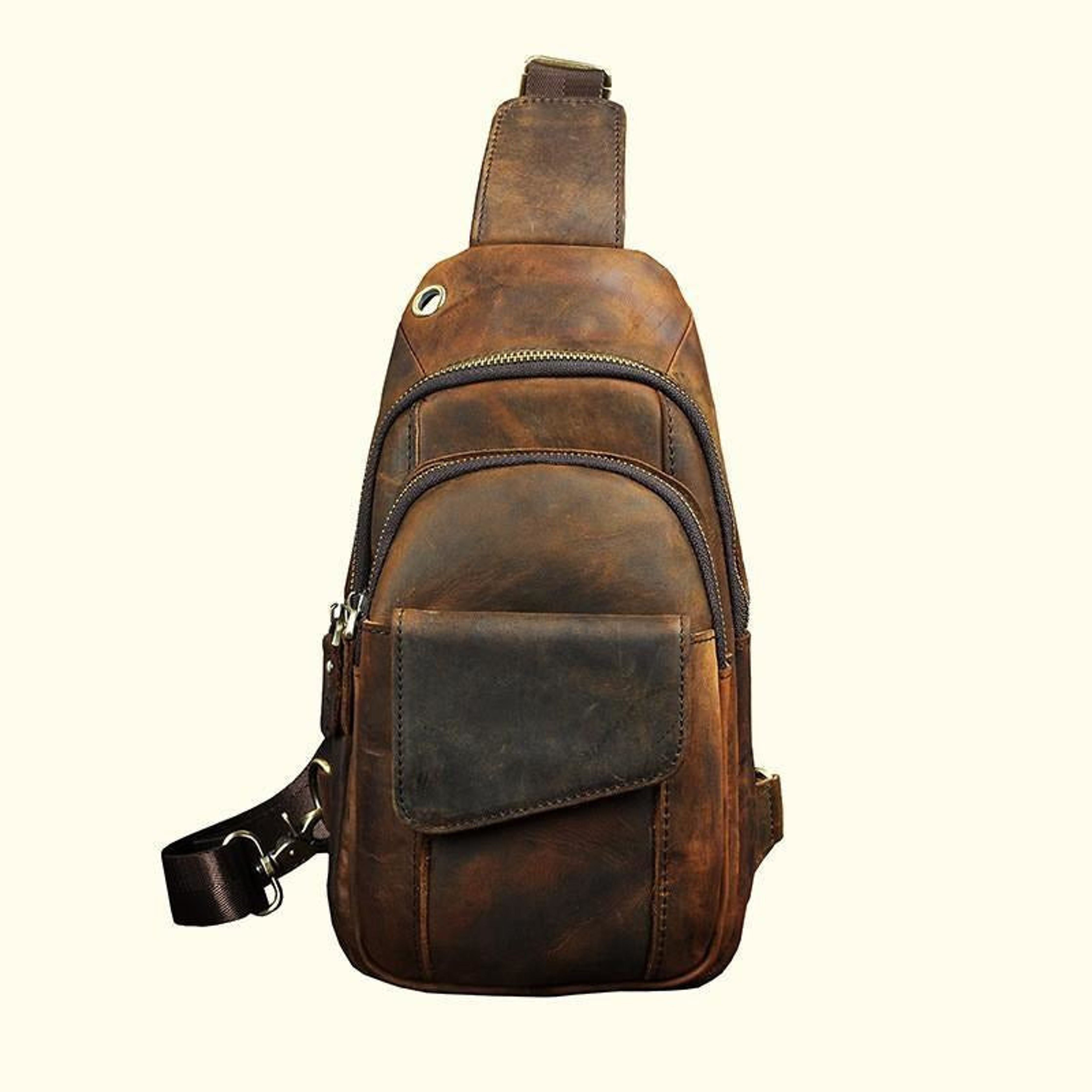 Brown leather sling bag on a white background