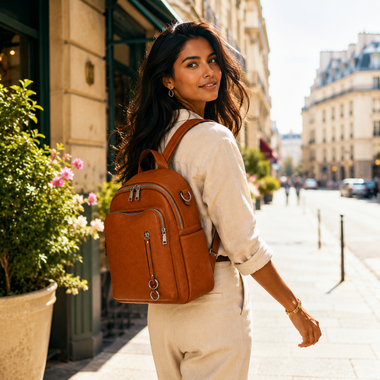 Woman with a brown backpack walking on a city street