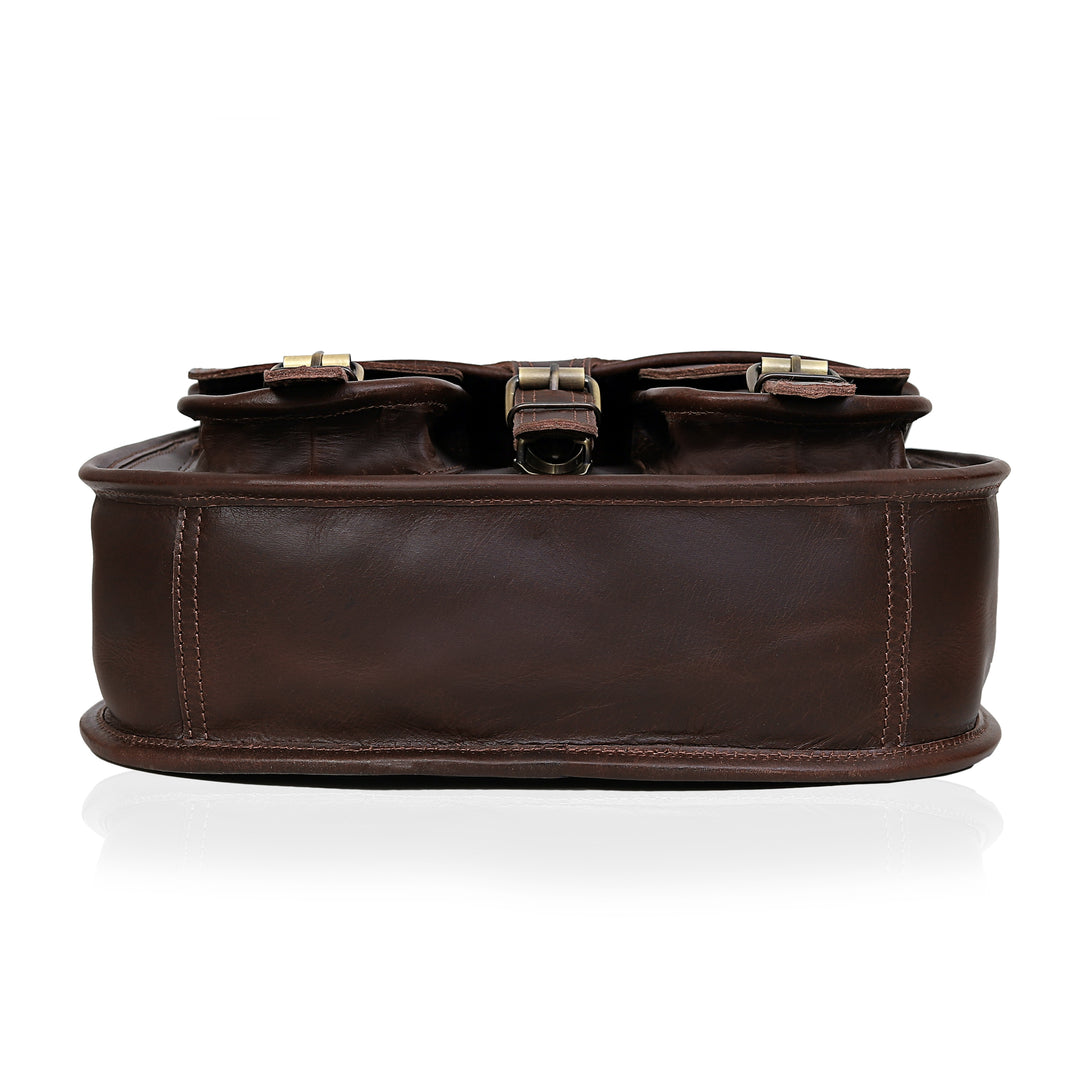 Brown leather bag with gold buckles on a white background