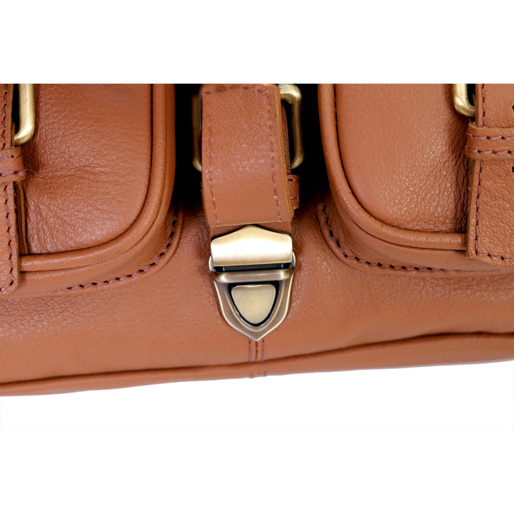Close-up of a brown leather bag with gold hardware on a white background