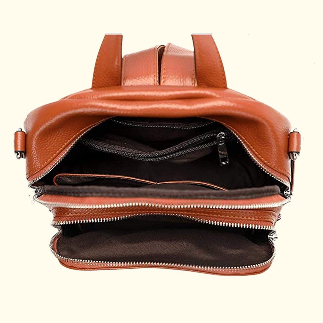 Brown leather backpack with open front compartment on a white background