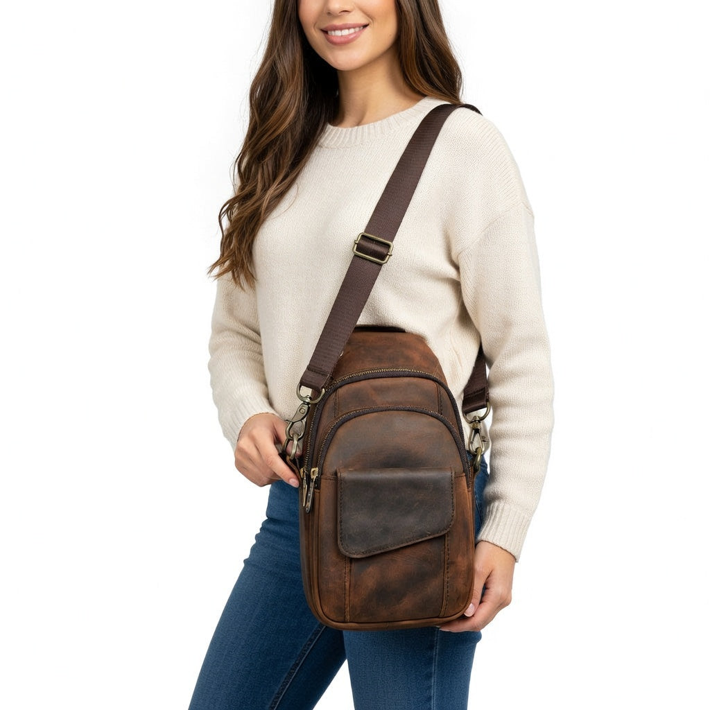 Woman wearing a brown leather crossbody bag on a white background
