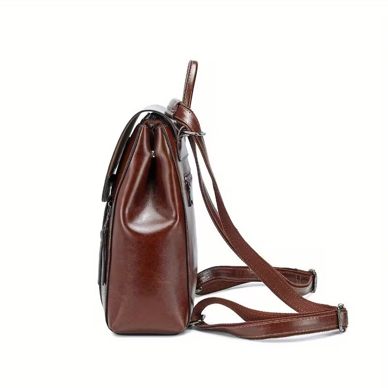 Brown leather backpack on a white background