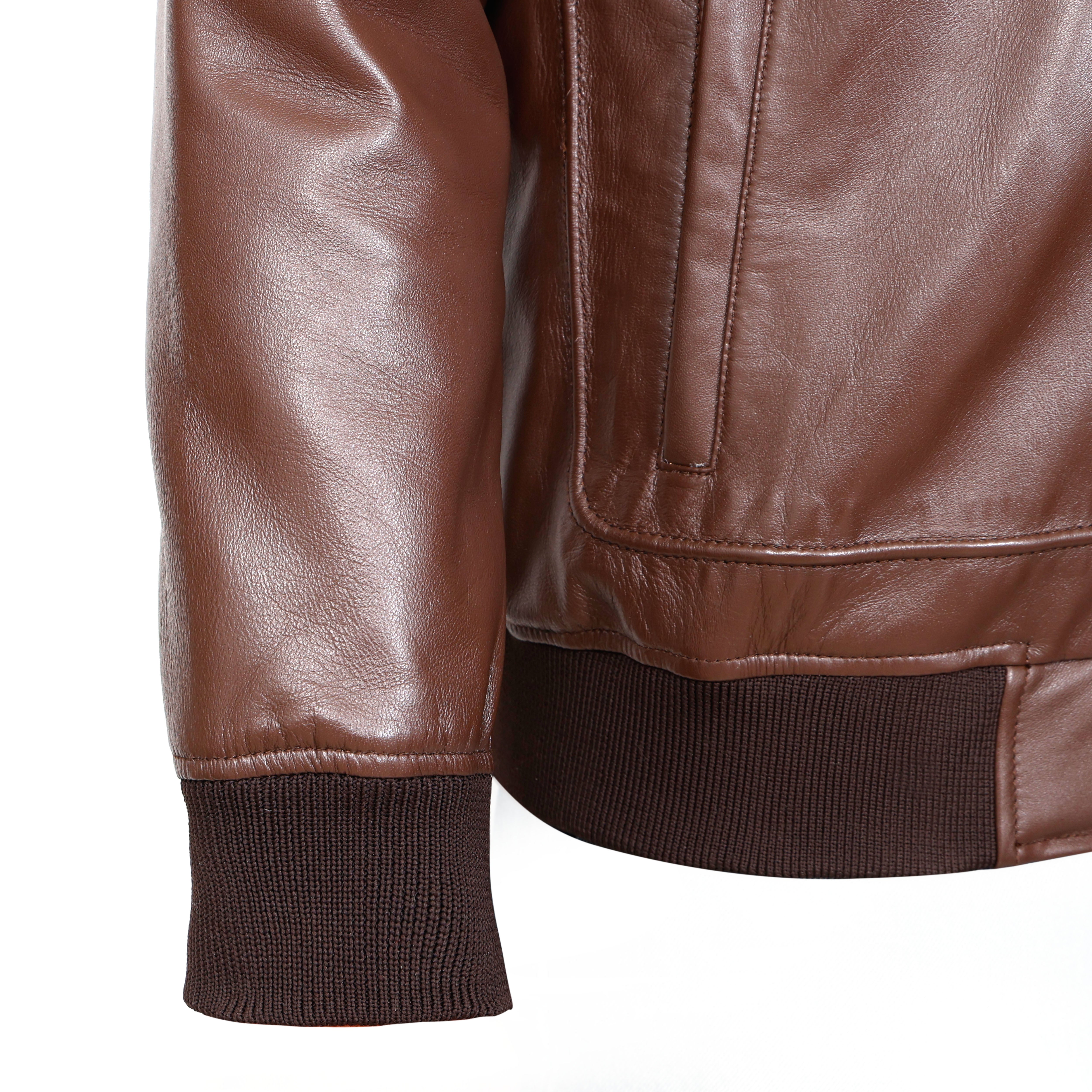 Close-up of a brown leather jacket on a white background