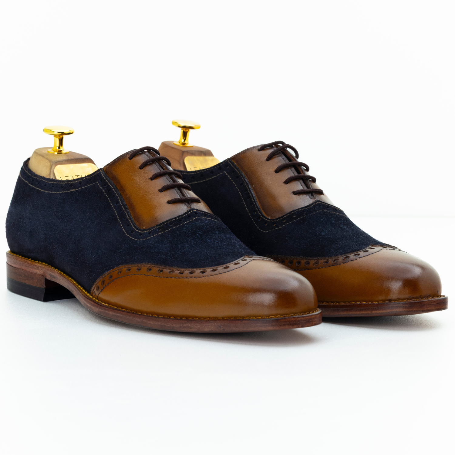 Pair of brown and black dress shoes on a white background