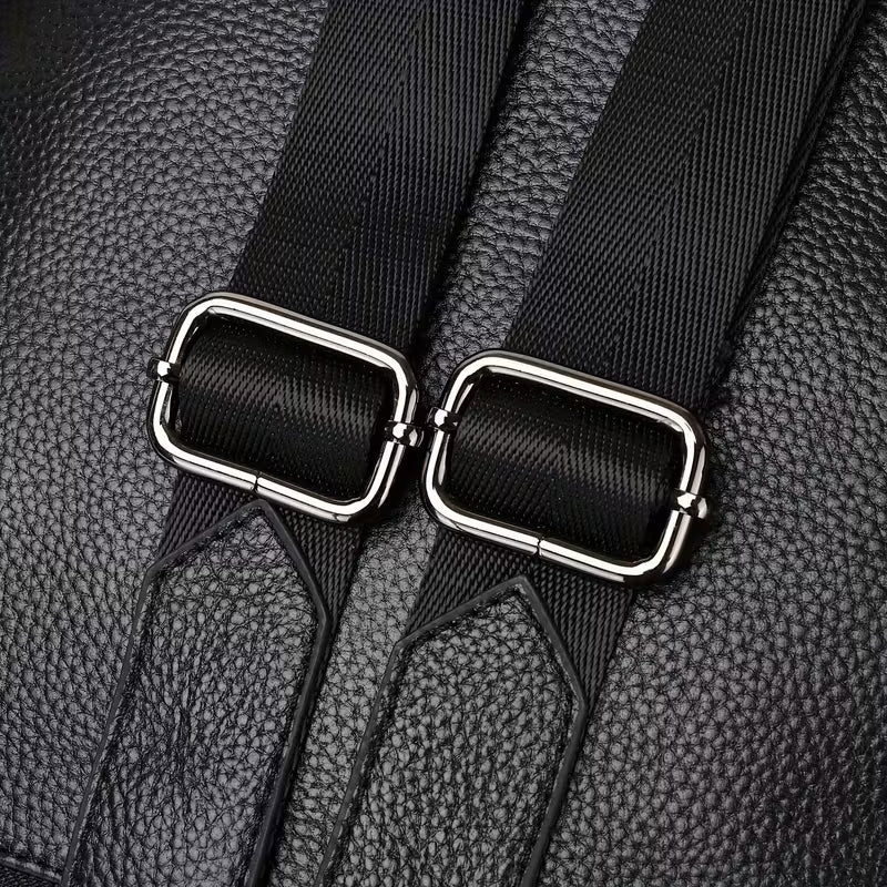 Close-up of black leather seat belt with metal buckle on a textured black background