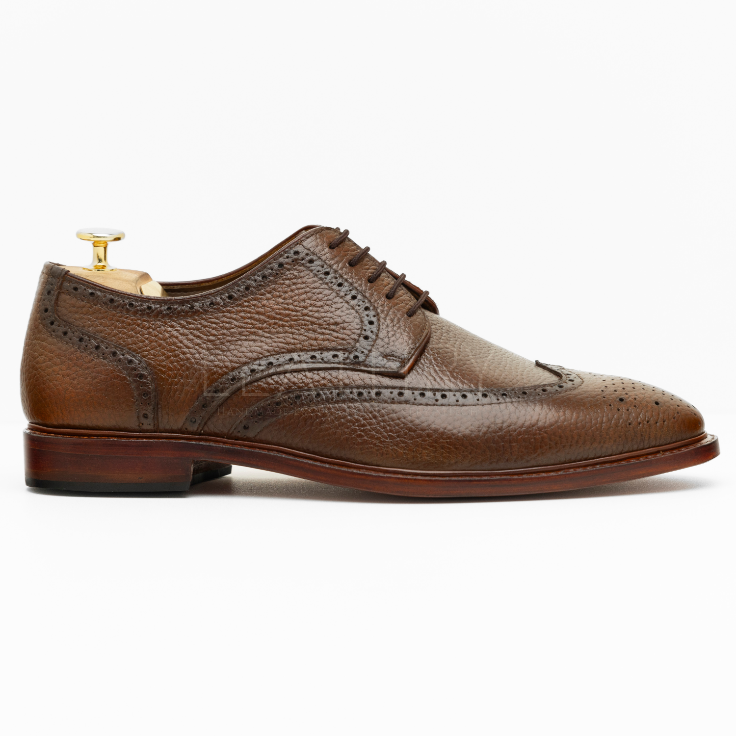 Brown leather dress shoe on a white background