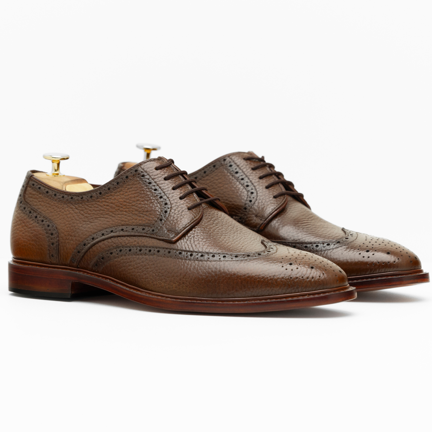 Pair of brown leather dress shoes on a white background