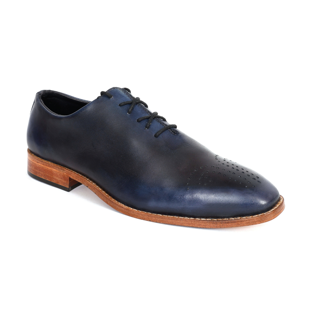 Navy leather shoe with brown sole on a white background