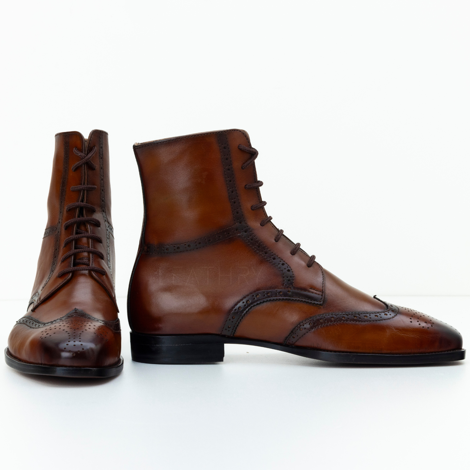 Pair of brown leather boots on a white background