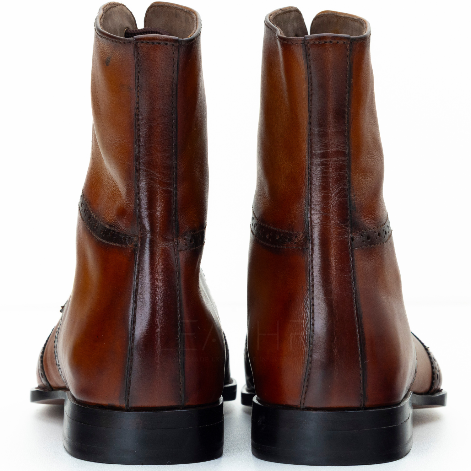 Pair of brown leather boots on a white background