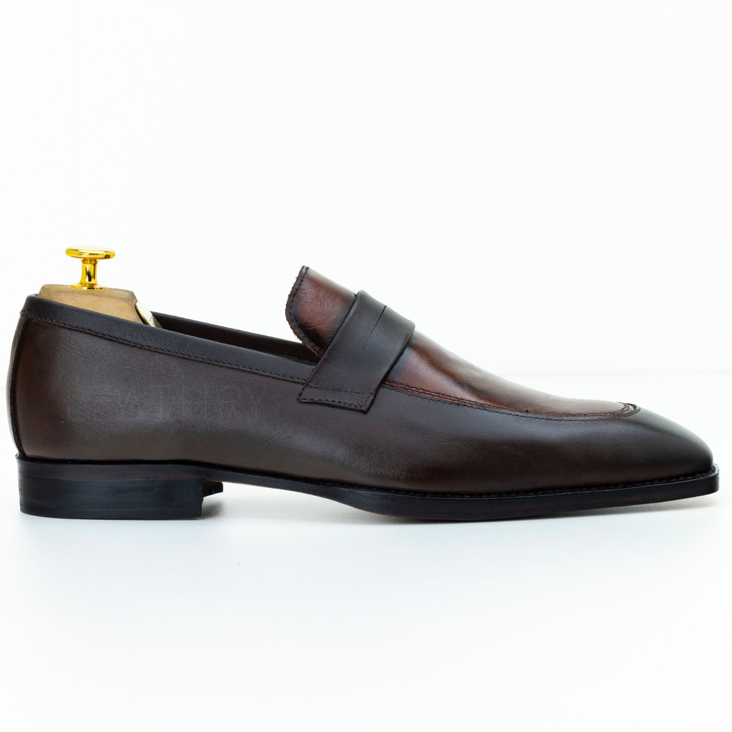 Brown leather loafer on a white background
