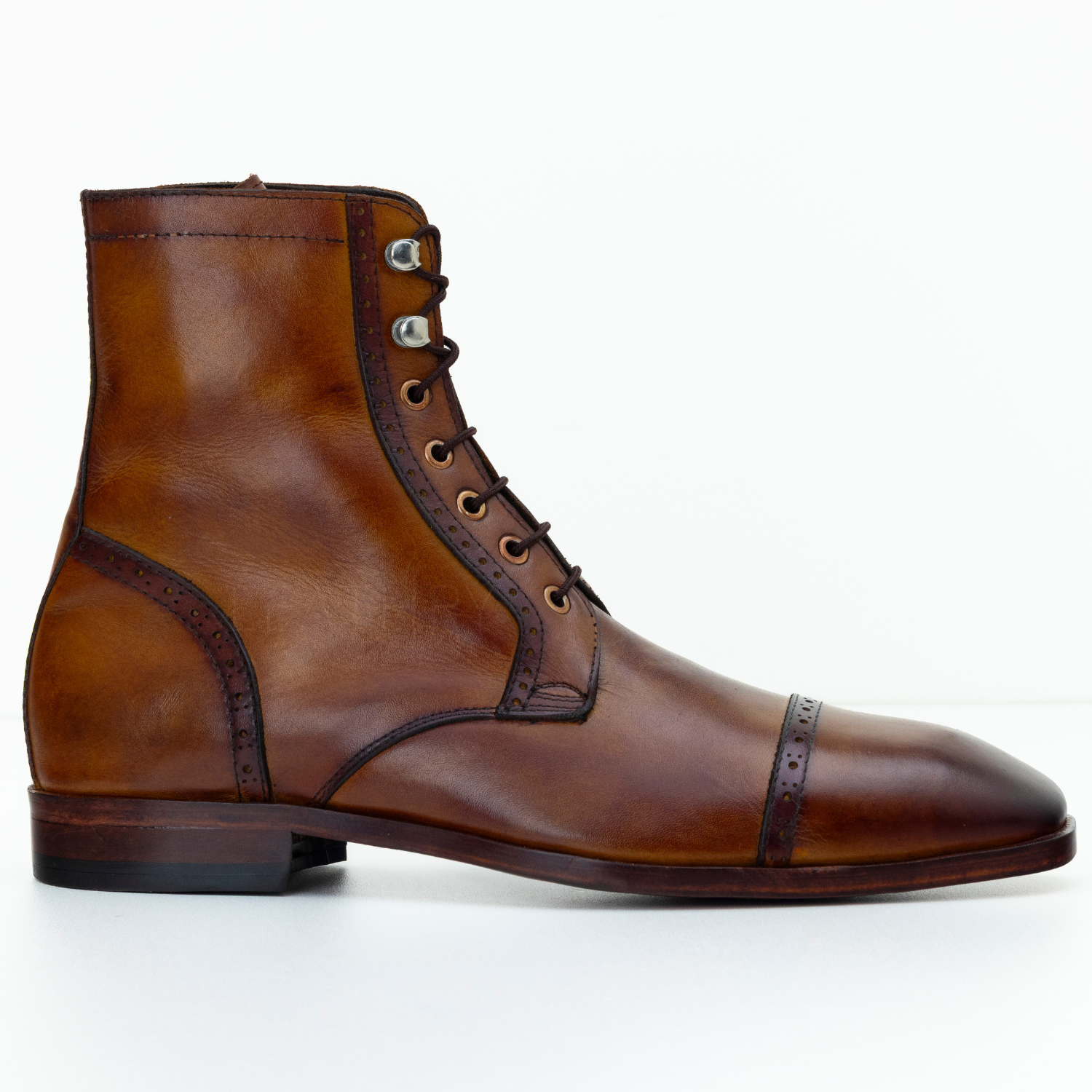 Brown leather boot with decorative lacing on a white background