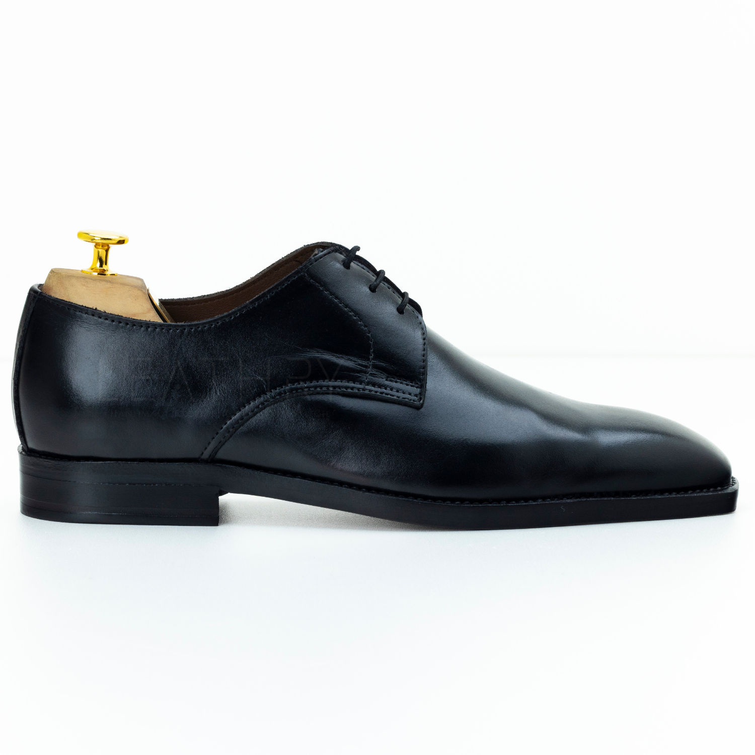 Black leather dress shoe on a white background