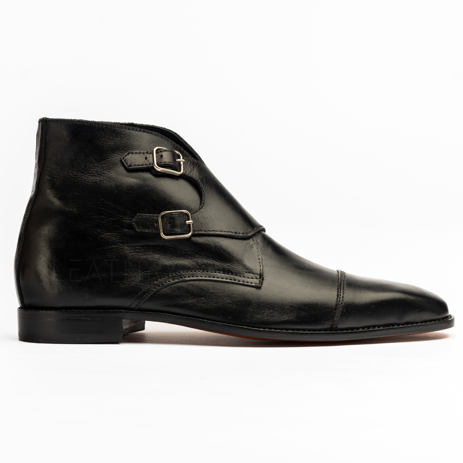 Black leather shoe with buckles on a white background