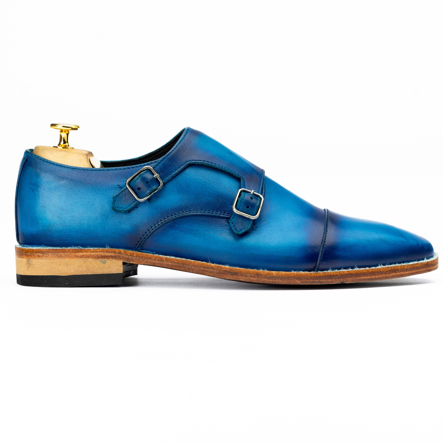 Blue leather dress shoe with a wooden sole on a white background