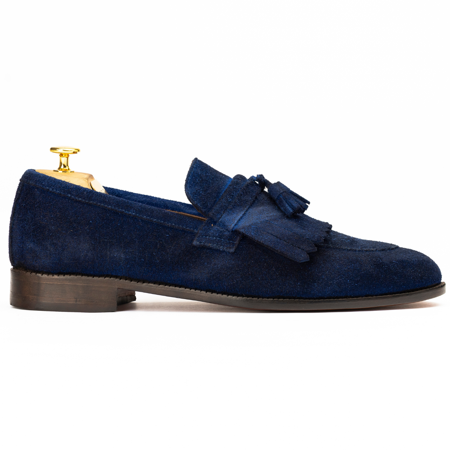 Blue suede loafer with tassels on a white background