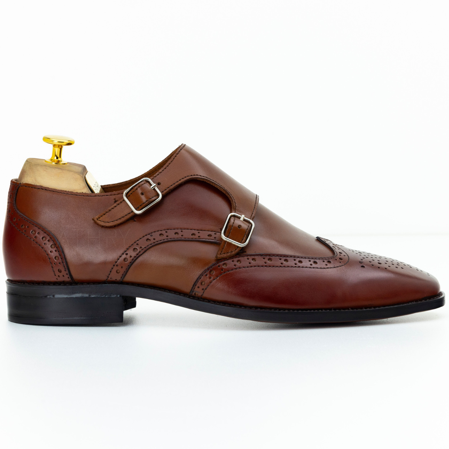 Brown leather dress shoe with a gold buckle on a white background