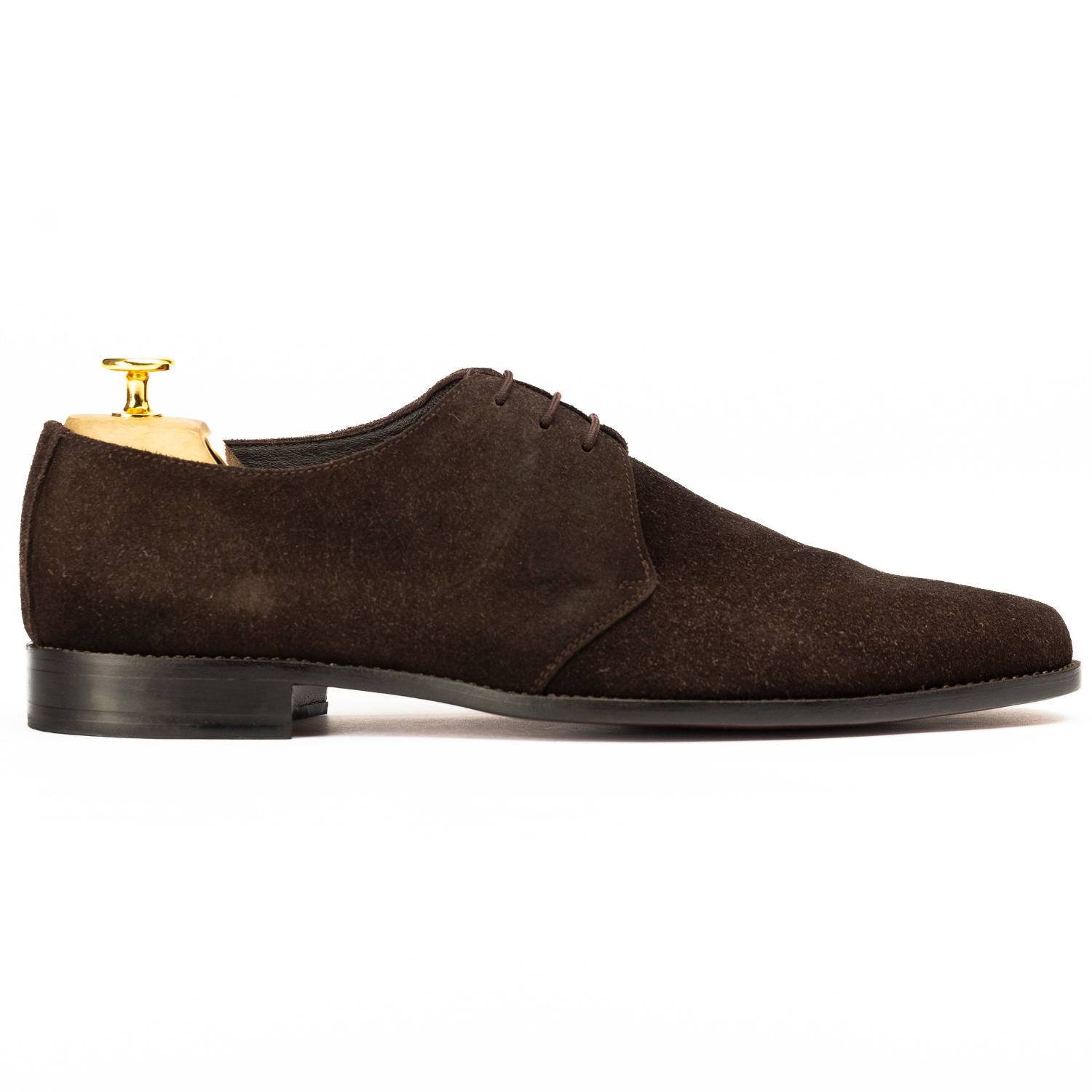 Brown suede dress shoe with a gold heel on a white background