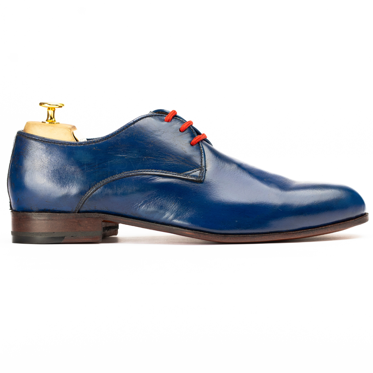 Blue leather shoe with red laces on a white background