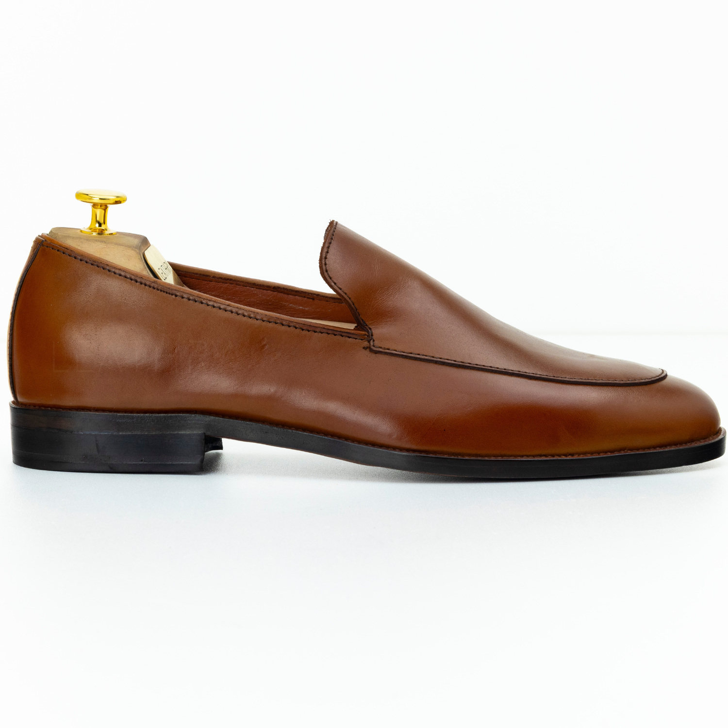 Brown leather loafer shoe on a white background