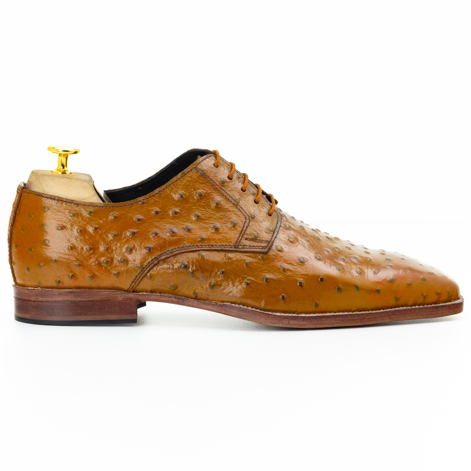 Brown leather dress shoe with detailed sole on a white background