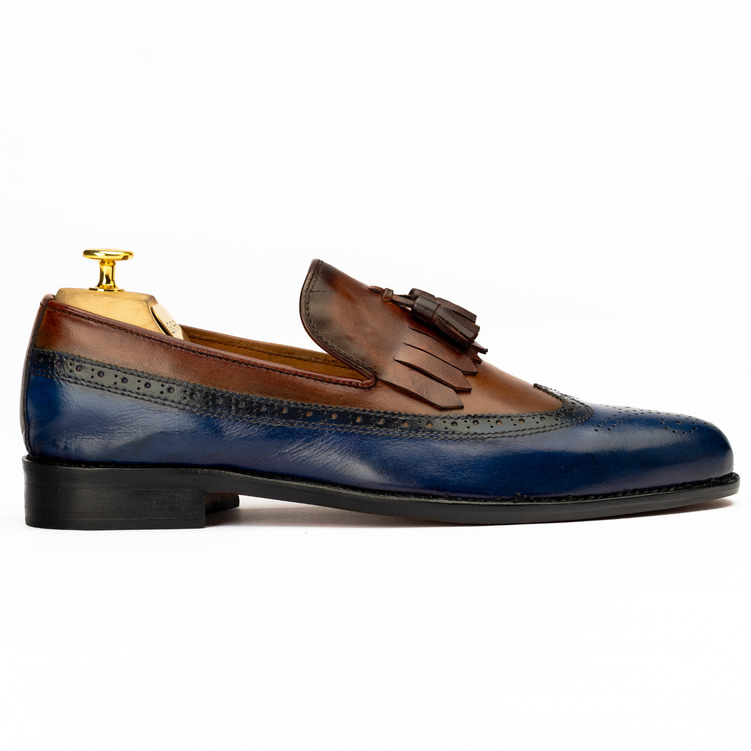 Brown and blue leather loafer with tassel on a white background