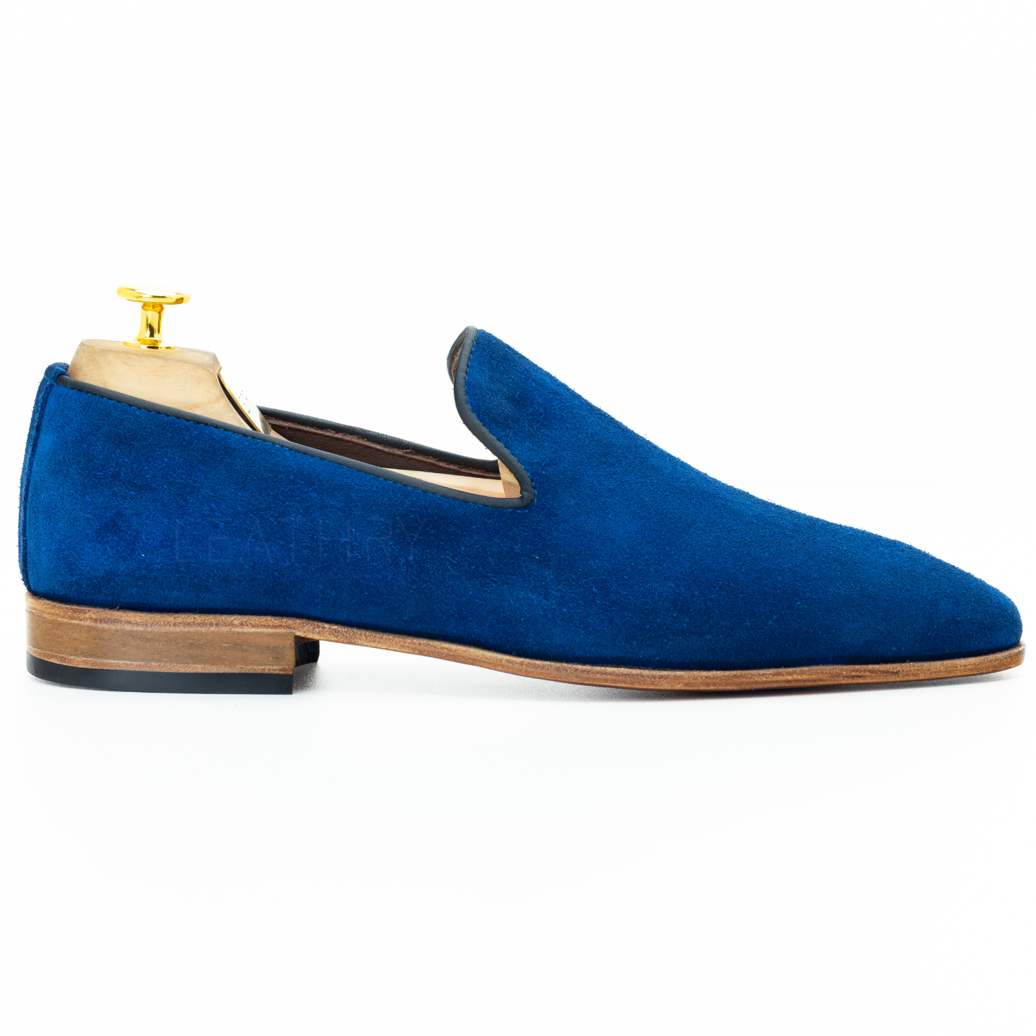 Blue suede loafer on a white background