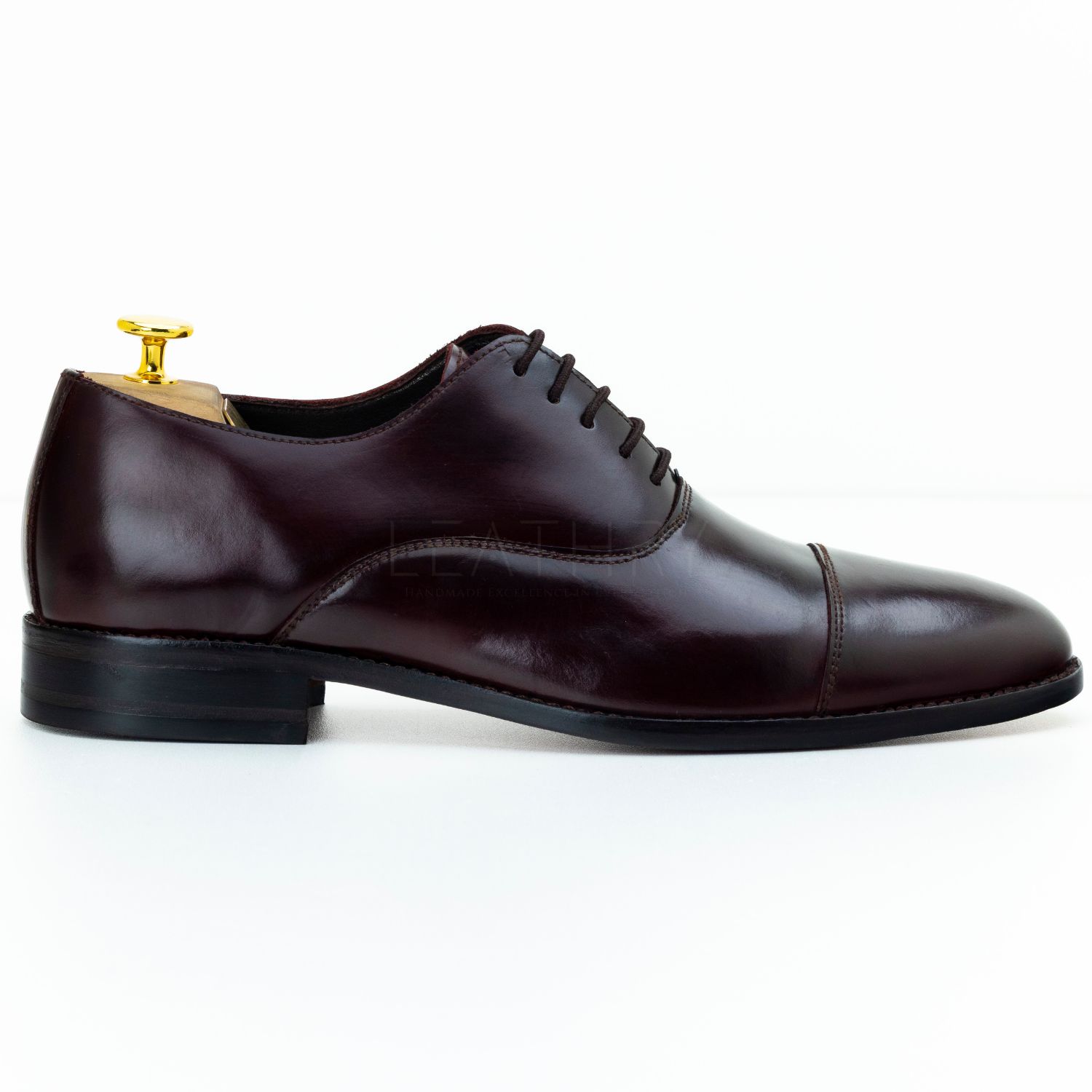 Brown leather dress shoe on a white background