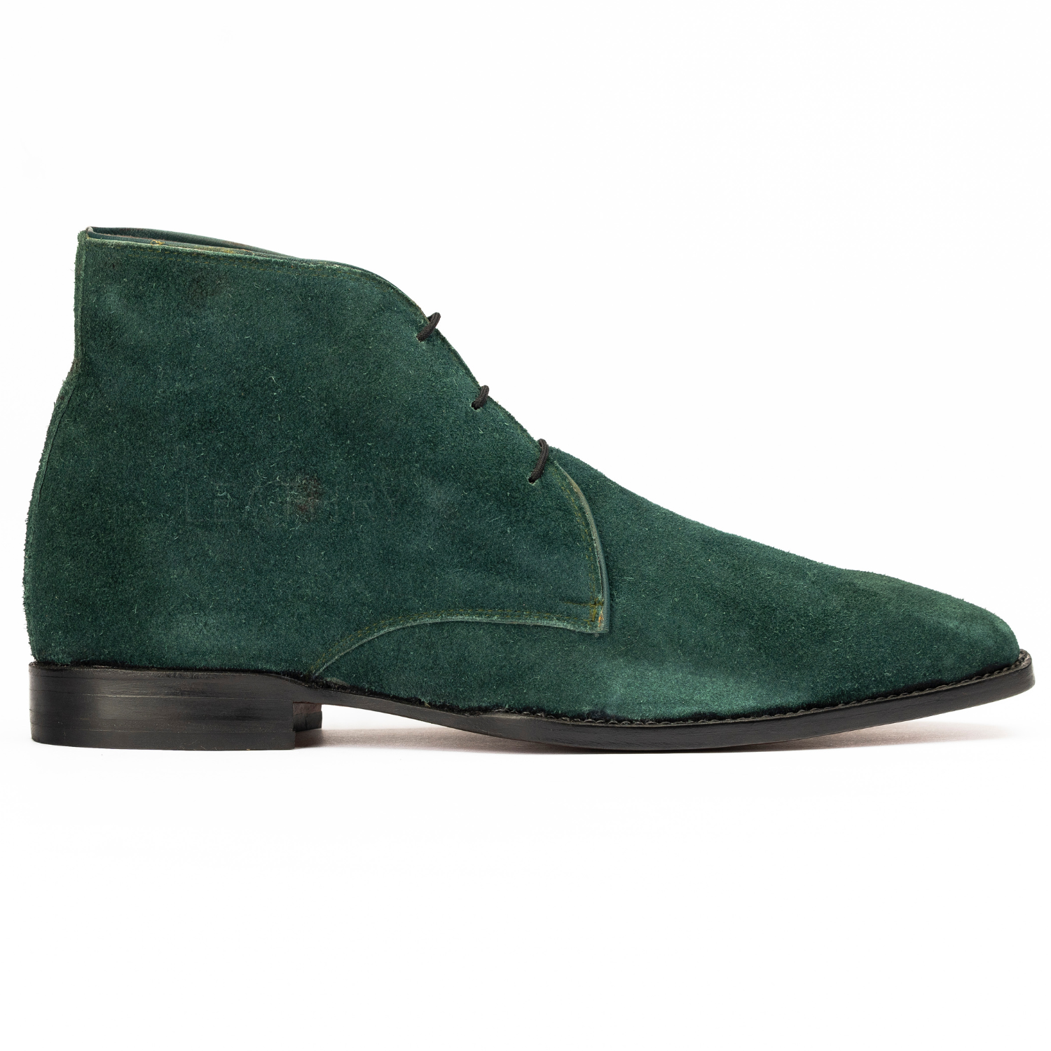 Green suede shoe on a white background