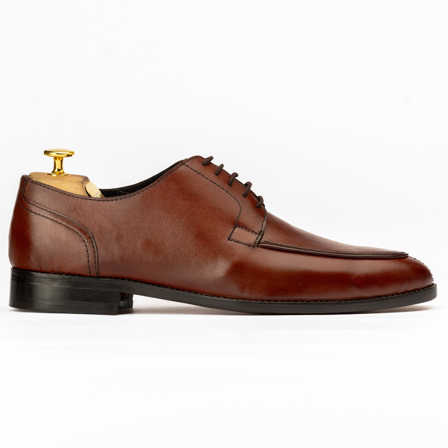 Brown leather dress shoe on a white background