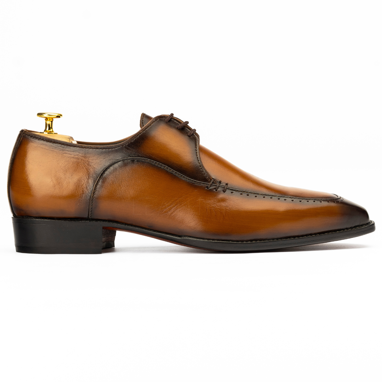 Brown leather dress shoe on a white background