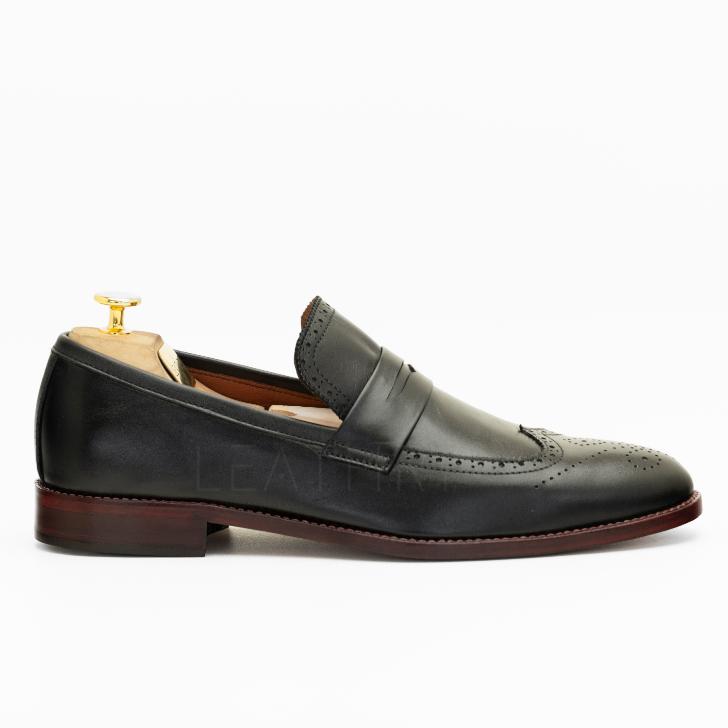 Black leather loafer shoe on a white background