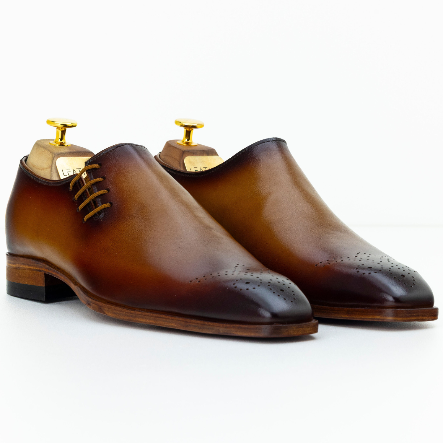 Pair of brown dress shoes on a white background