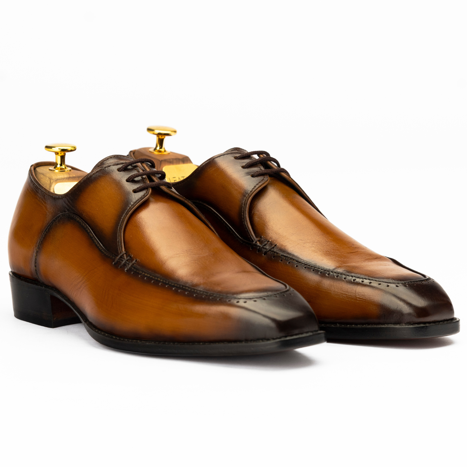 Pair of brown dress shoes on a white background