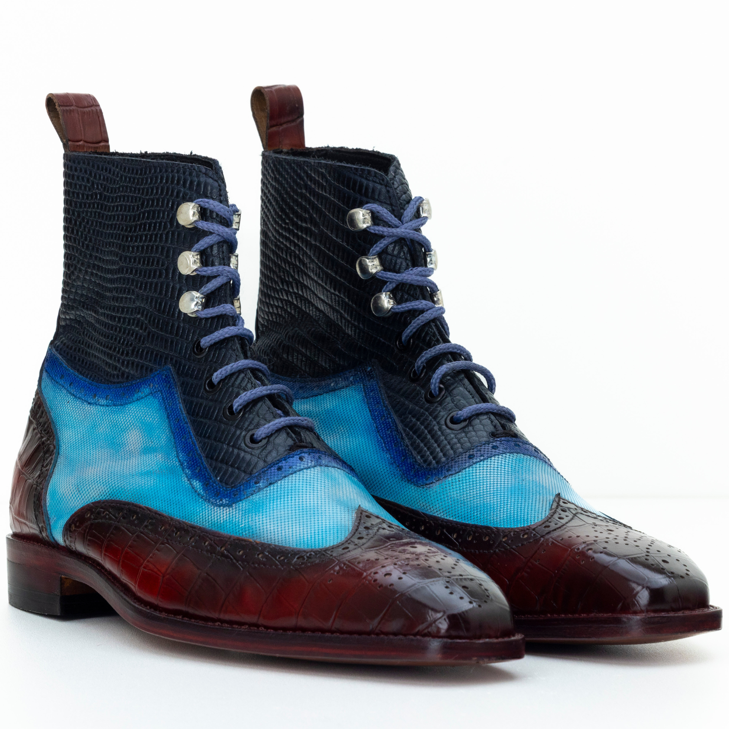 Pair of blue and brown dress boots on a white background