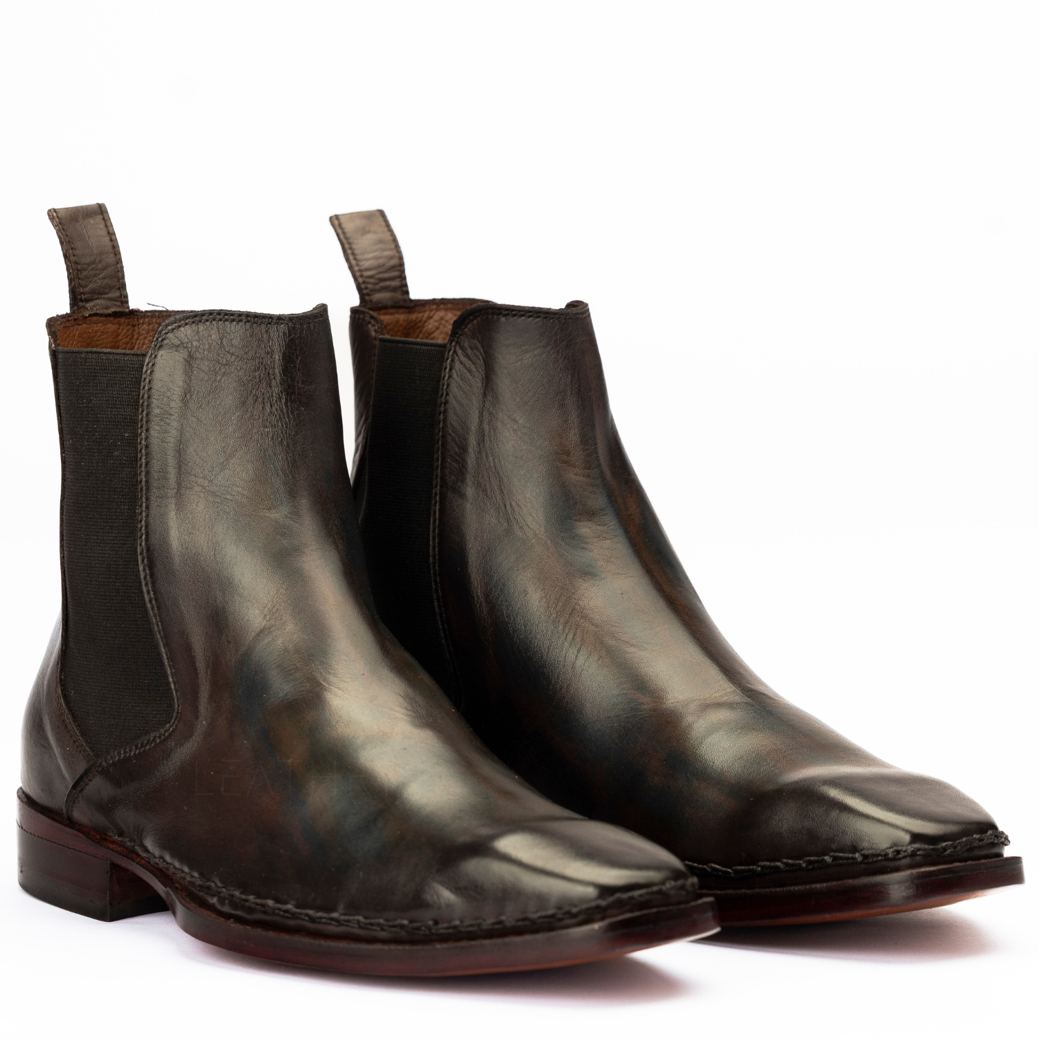 Pair of brown leather boots on a white background