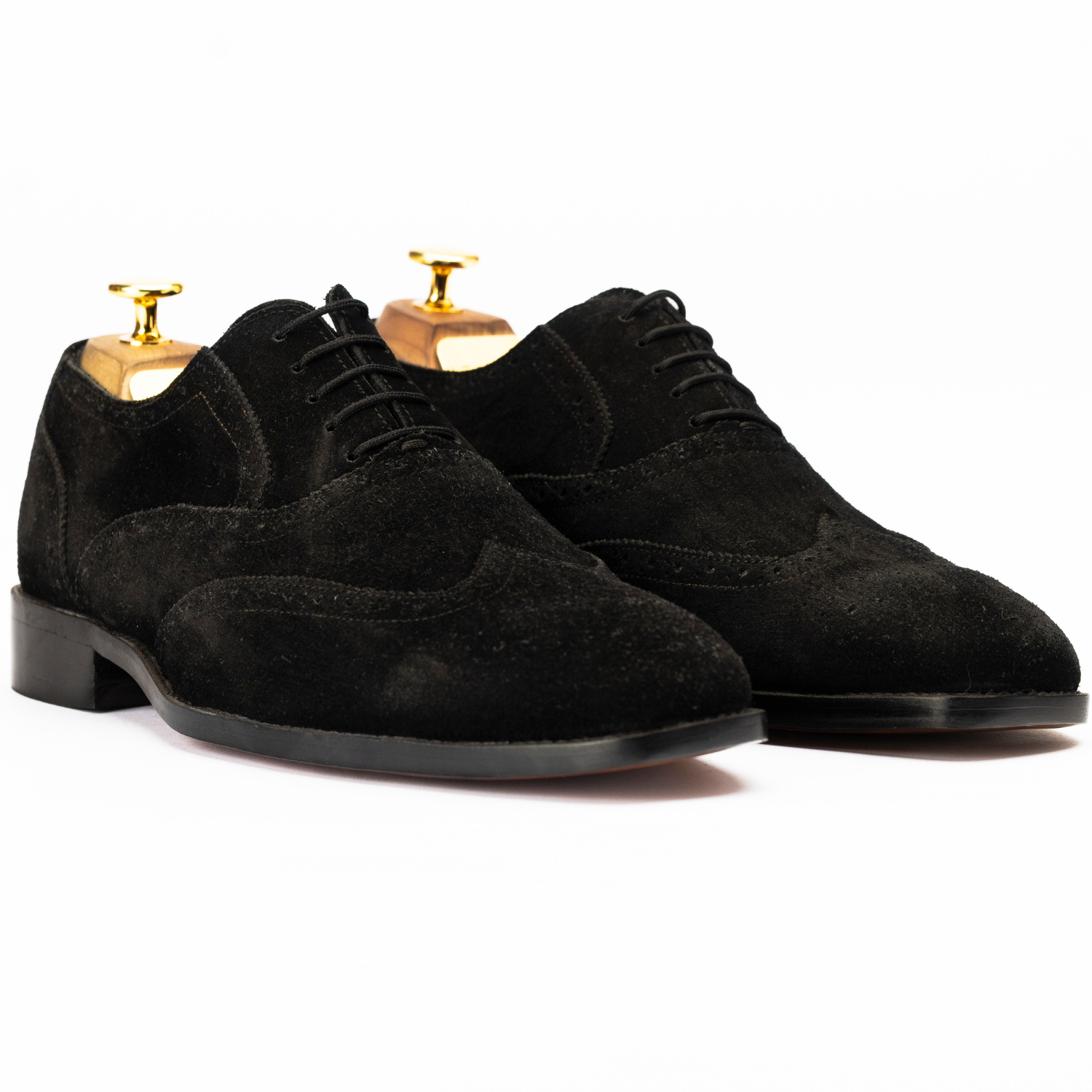 Pair of black suede dress shoes on a white background