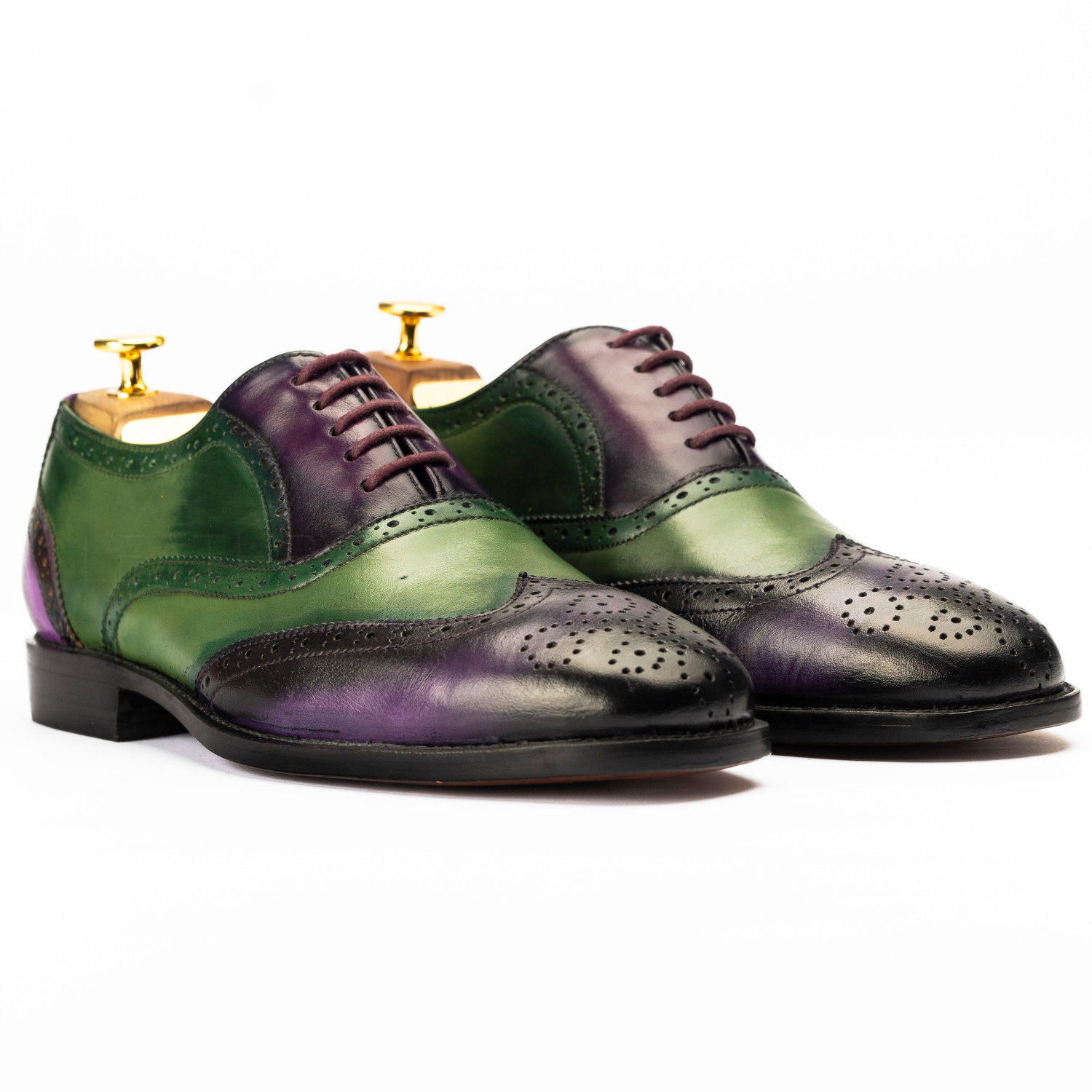 Green and purple dress shoes on a white background