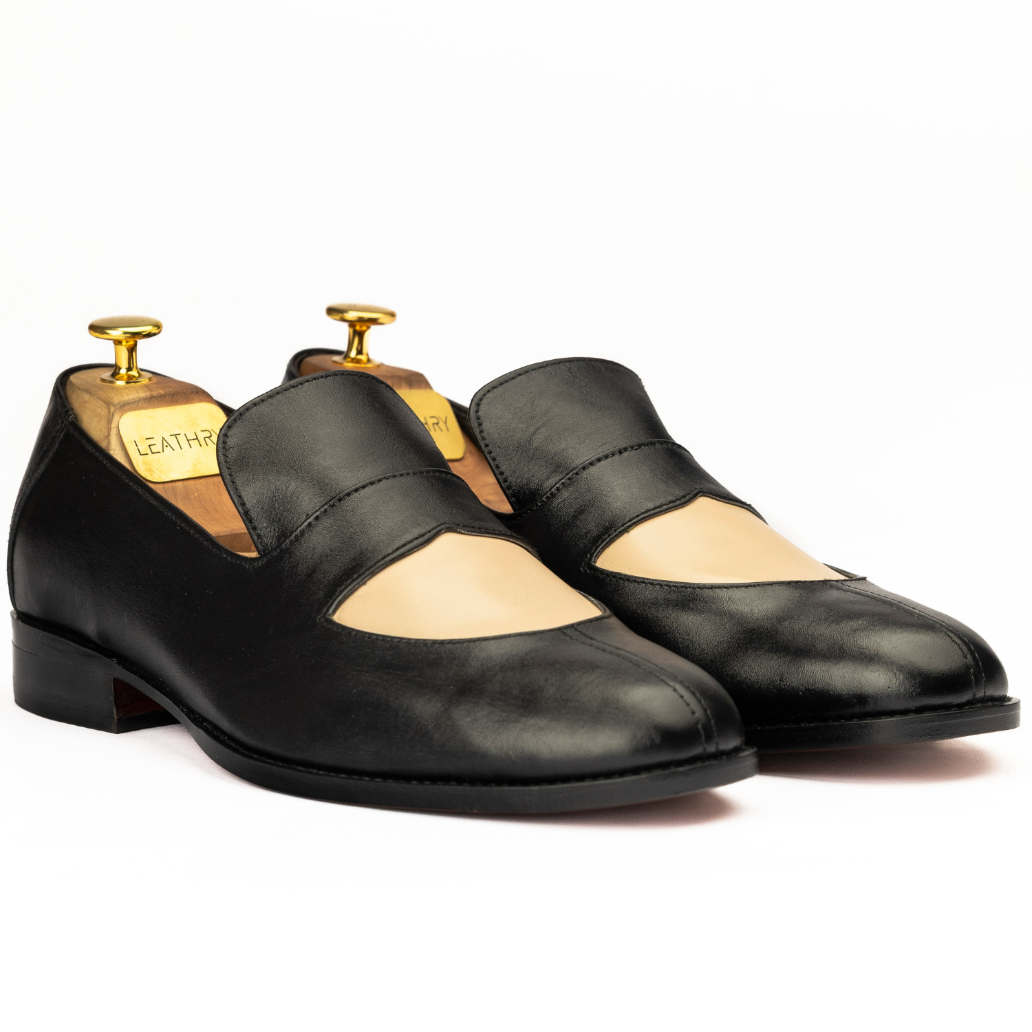 Pair of black leather shoes on a white background