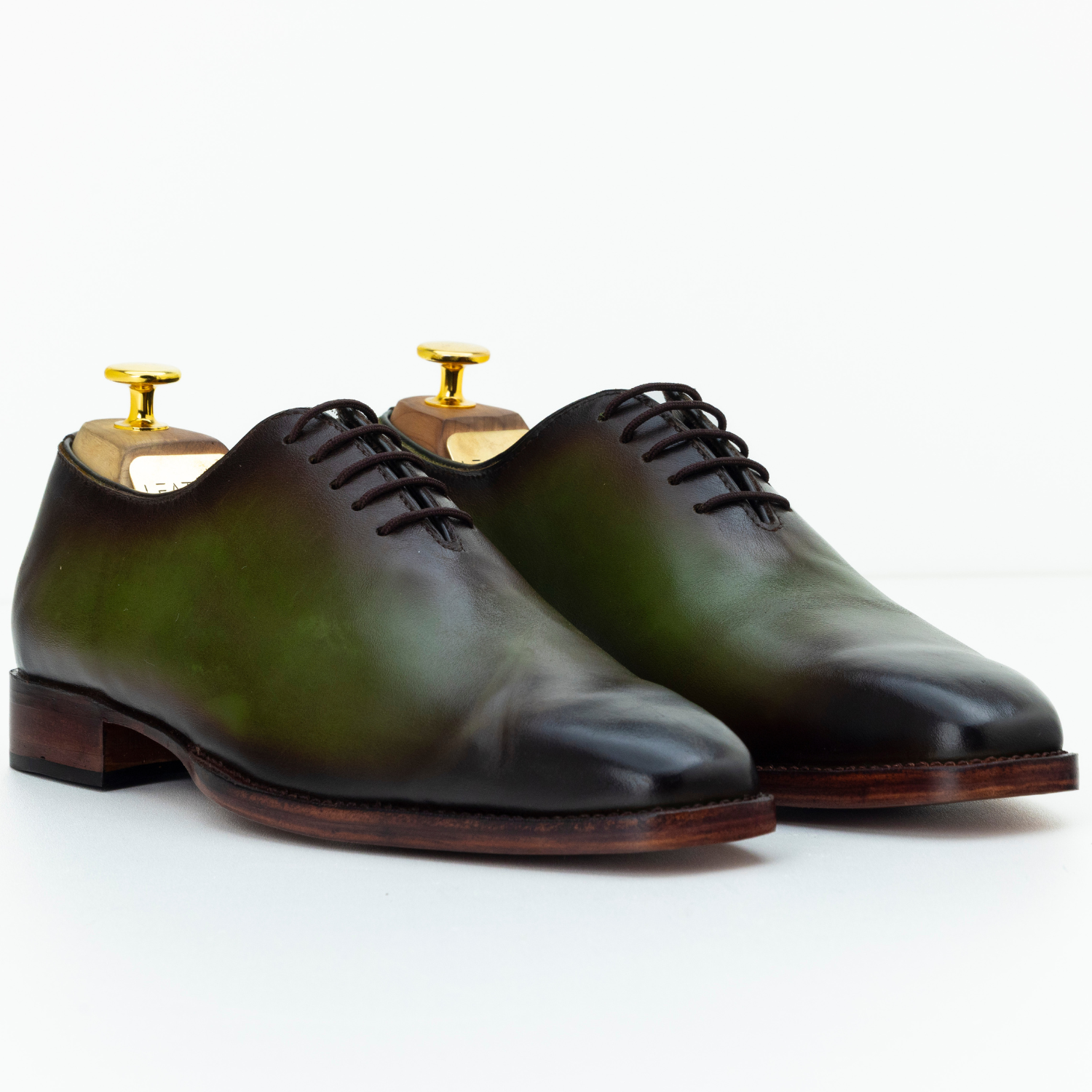 Pair of polished leather shoes on a white background
